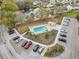 Aerial view showcasing a community pool with a patio, lounge chairs, landscaping, and parking at 960 Starkey Rd # 2405, Largo, FL 33771