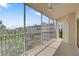 Screened balcony offering a view of the community, palm trees, and beautiful blue sky at 960 Starkey Rd # 2405, Largo, FL 33771