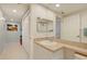 Bathroom with beige countertops, white cabinets, and a view of the hall at 960 Starkey Rd # 2405, Largo, FL 33771