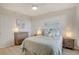 Cozy bedroom with a ceiling fan, blue bedding, neutral walls and wood-look floors at 960 Starkey Rd # 2405, Largo, FL 33771