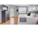 Bright main bedroom with wood floors, large windows, and television at 960 Starkey Rd # 2405, Largo, FL 33771