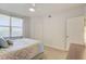 Bright bedroom with ceiling fan, closet, and a large window with blinds at 960 Starkey Rd # 2405, Largo, FL 33771