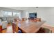 Open-concept dining and living space features a large wood table and comfortable sectional sofa at 960 Starkey Rd # 2405, Largo, FL 33771