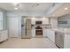 Modern kitchen featuring stainless steel appliances, a ceiling fan, and white cabinetry at 960 Starkey Rd # 2405, Largo, FL 33771