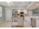 Open-concept kitchen with stainless steel appliances, white cabinets and a rolling island at 960 Starkey Rd # 2405, Largo, FL 33771