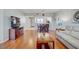 Open-concept living space features a large television, wood floors, and access to the kitchen at 960 Starkey Rd # 2405, Largo, FL 33771