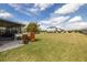 Large backyard features an enclosed porch area, lush lawn, and plenty of space for outdoor enjoyment at 9814 Palazzo St, Seffner, FL 33584