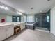 Bright bathroom featuring a walk in shower, soaking tub, double vanity, and tile flooring at 9814 Palazzo St, Seffner, FL 33584