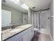 Bathroom featuring a granite vanity, tile flooring, and a shower at 9814 Palazzo St, Seffner, FL 33584