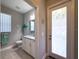 Bathroom featuring vanity, a decorative door, and natural light at 9814 Palazzo St, Seffner, FL 33584