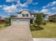 Charming home with a well-maintained lawn, brick-paved driveway, and a welcoming two-car garage at 9814 Palazzo St, Seffner, FL 33584