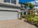 Charming home featuring a two-car garage, beautiful landscaping, and a brick-paved driveway at 9814 Palazzo St, Seffner, FL 33584
