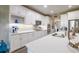 Modern kitchen featuring white cabinetry, quartz countertops, stainless steel appliances, and ample storage at 9814 Palazzo St, Seffner, FL 33584
