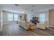 Spacious living room with neutral tones, large windows, and comfortable seating at 9814 Palazzo St, Seffner, FL 33584