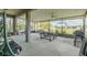 Enclosed patio featuring comfortable seating, an outdoor grill, and outdoor ceiling fans at 9814 Palazzo St, Seffner, FL 33584