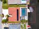 Waterfront property with pool and boat dock, featuring a red tile roof and solar panels at 9909 San Mateo Way, Port Richey, FL 34668