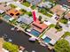 Aerial view of canal front homes, featuring a home with a red tile roof and a private dock at 9909 San Mateo Way, Port Richey, FL 34668