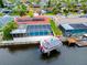 Aerial view of canal front home with private pool and boat dock at 9909 San Mateo Way, Port Richey, FL 34668