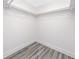 Bright, empty walk-in closet with plenty of hanging space for storing clothes and accessories at 9909 San Mateo Way, Port Richey, FL 34668