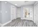 Bright foyer with stylish flooring, a decorative glass front door, and fresh white trim and doors at 9909 San Mateo Way, Port Richey, FL 34668