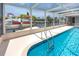 Beautiful pool with canal views, enclosed in a screened patio for year-round enjoyment at 9909 San Mateo Way, Port Richey, FL 34668