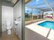 Convenient pool bathroom with toilet and sink, located near the enclosed pool area at 9909 San Mateo Way, Port Richey, FL 34668