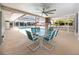 Spacious screened-in pool patio with dining furniture, offering a comfortable outdoor space at 9909 San Mateo Way, Port Richey, FL 34668