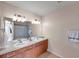 Well-lit bathroom with double sinks, spacious countertop and shower-tub combination at 10217 Westpark Preserve Blvd, Tampa, FL 33625