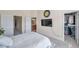 Neutral bedroom with carpet, tv, and walk in closet at 10217 Westpark Preserve Blvd, Tampa, FL 33625