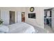 Cozy bedroom with carpet floors, featuring television and an open walk-in closet at 10217 Westpark Preserve Blvd, Tampa, FL 33625