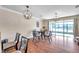 Cozy dining room featuring hardwood floors, modern lighting fixtures, and sliding glass doors at 10217 Westpark Preserve Blvd, Tampa, FL 33625