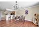 Cozy dining room featuring hardwood floors, modern lighting fixtures, and adjacent kitchen at 10217 Westpark Preserve Blvd, Tampa, FL 33625