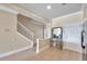 Inviting entryway with tile flooring, staircase, neutral paint, and access to the kitchen and other rooms at 10217 Westpark Preserve Blvd, Tampa, FL 33625