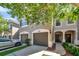 Charming townhome featuring a two-car garage, and a welcoming front entrance with decorative door at 10217 Westpark Preserve Blvd, Tampa, FL 33625