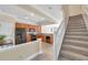 Bright open kitchen adjacent to carpeted staircase, featuring modern appliances and tile flooring at 10217 Westpark Preserve Blvd, Tampa, FL 33625