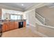 The cozy kitchen adjacent to carpeted stairway has modern appliances and lots of natural light at 10217 Westpark Preserve Blvd, Tampa, FL 33625