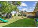 Large backyard features recreation equipment and outdoor seating at 10387 Majestic Dr, Largo, FL 33774
