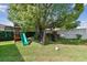 The property has a backyard with recreational equipment including a slide, swings and soccer net at 10387 Majestic Dr, Largo, FL 33774