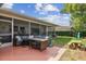 Rear patio with screened-in portion, table, and fenced-in yard and playground at 10387 Majestic Dr, Largo, FL 33774