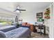 Secondary bedroom with two twin beds, ceiling fan, and decorated walls at 10387 Majestic Dr, Largo, FL 33774