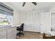 Bright bedroom with large closet, work space, and a gray dresser at 10387 Majestic Dr, Largo, FL 33774