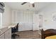 Cozy bedroom featuring a spacious closet, desk, and light wood-look floors at 10387 Majestic Dr, Largo, FL 33774