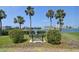 A tranquil waterfront bench surrounded by lush greenery, perfect for relaxation and enjoying the serene views at 10387 Majestic Dr, Largo, FL 33774