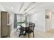 Dining area with a rustic table, a bench, and ample natural light from a large window at 10387 Majestic Dr, Largo, FL 33774