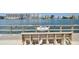 Community dock with seating offers a relaxing spot to enjoy waterfront views and community gatherings at 10387 Majestic Dr, Largo, FL 33774