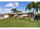 Beautiful single-story home with a green lawn, brick accents, and a two-car garage at 10387 Majestic Dr, Largo, FL 33774