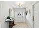 Bright foyer featuring tile flooring, neutral walls, and a view of the entryway door at 10387 Majestic Dr, Largo, FL 33774