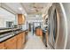 Long view of the kitchen featuring stainless steel appliances and modern cabinetry at 10387 Majestic Dr, Largo, FL 33774