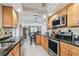 Kitchen with stainless steel appliances, stone countertops, and an adjacent dining area at 10387 Majestic Dr, Largo, FL 33774