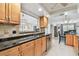 Updated kitchen with granite countertops, stainless steel appliances, and a window overlooking the backyard at 10387 Majestic Dr, Largo, FL 33774
